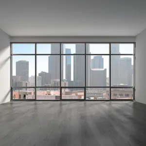 Empty room with large windows, representing real estate.